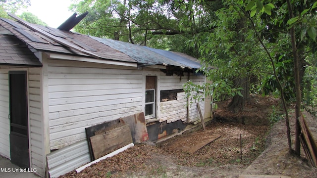 3001 Hewes Ave, Gulfport, MS 39507 - view of side of home featuring an outbuilding and roof with shingles
