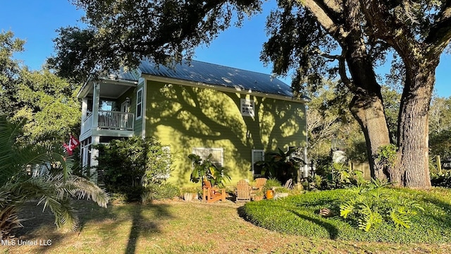 view of home's exterior with a balcony