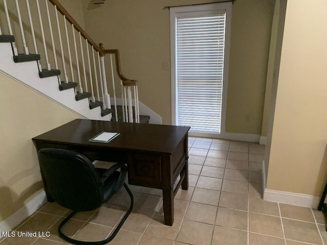 home office with light tile patterned flooring and baseboards