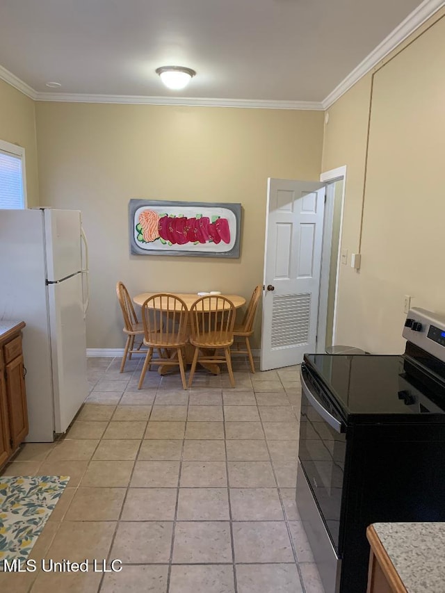kitchen featuring black electric range, light tile patterned floors, crown molding, and freestanding refrigerator