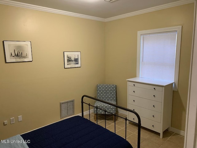 bedroom with ornamental molding, visible vents, light tile patterned floors, and baseboards