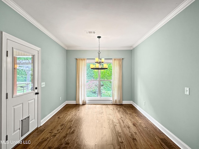 unfurnished dining area featuring dark wood-type flooring, a chandelier, baseboards, and ornamental molding