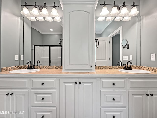 full bathroom with crown molding and double vanity