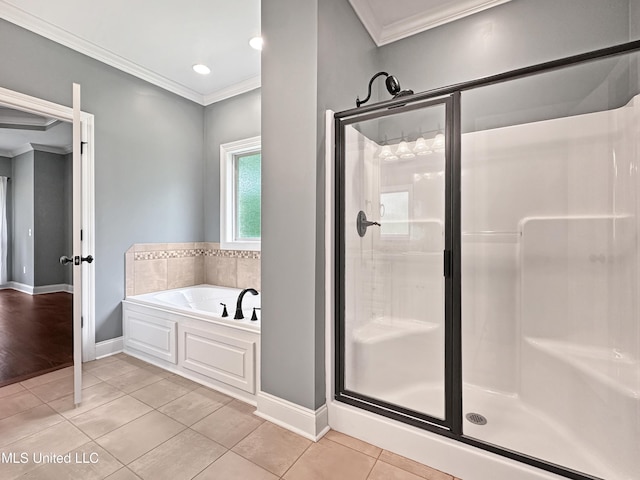 full bath with ornamental molding, a shower stall, tile patterned flooring, baseboards, and a bath