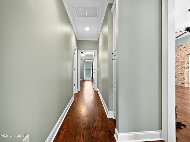 corridor with crown molding, dark wood-style floors, and baseboards