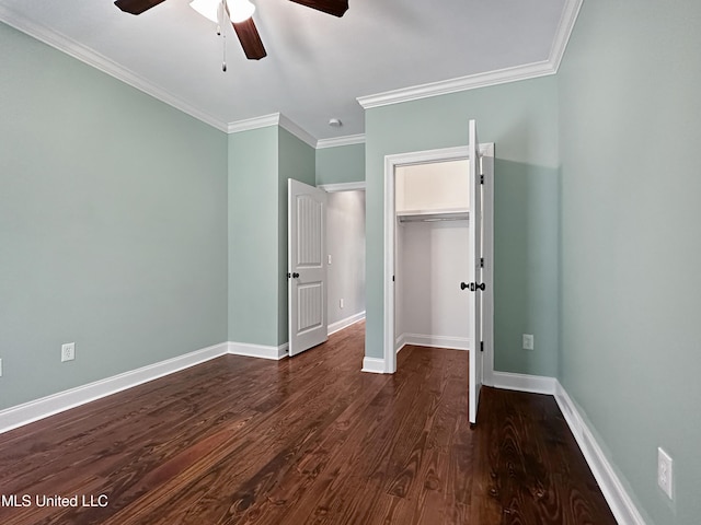unfurnished bedroom with ornamental molding, dark wood-style flooring, baseboards, a closet, and a ceiling fan