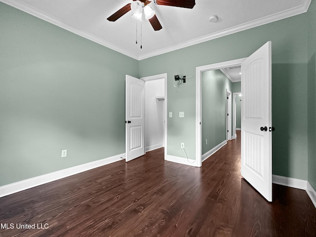 unfurnished bedroom featuring ornamental molding, dark wood-type flooring, baseboards, and a ceiling fan