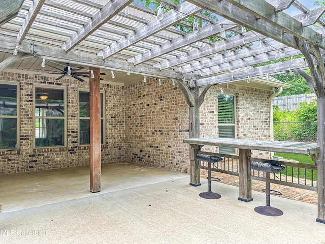 view of patio / terrace featuring fence, a pergola, outdoor dining space, and a ceiling fan