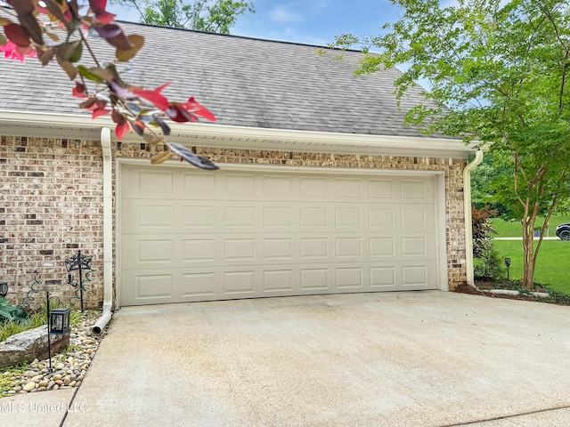 garage featuring concrete driveway