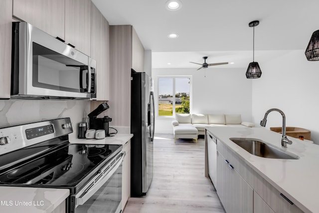 1302 Magnolia St Unit A101, Gulfport, MS 39507 - kitchen featuring stainless steel appliances, modern cabinets, light countertops, light wood-style flooring, and recessed lighting