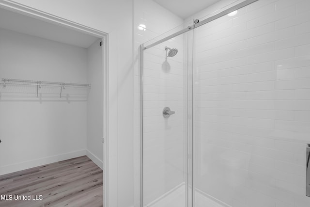 1302 Magnolia St Unit A101, Gulfport, MS 39507 - full bathroom with a shower stall, a spacious closet, and wood finished floors