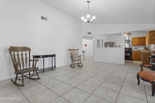 sitting room with sink, light tile patterned floors, a chandelier, and high vaulted ceiling