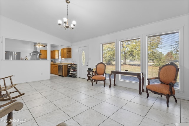 sitting room featuring ceiling fan with notable chandelier, light tile patterned flooring, and vaulted ceiling