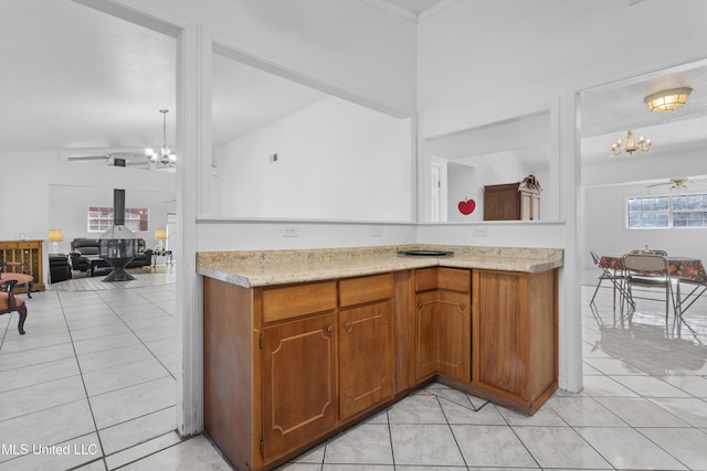 kitchen featuring ceiling fan with notable chandelier and light tile patterned flooring