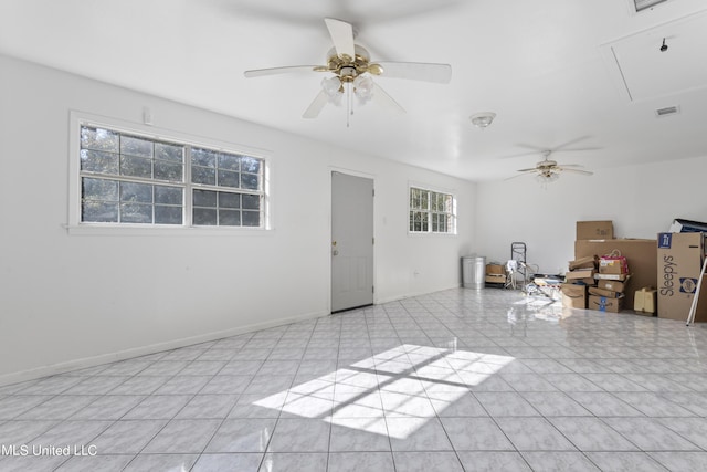 unfurnished living room featuring light tile patterned floors, plenty of natural light, and ceiling fan