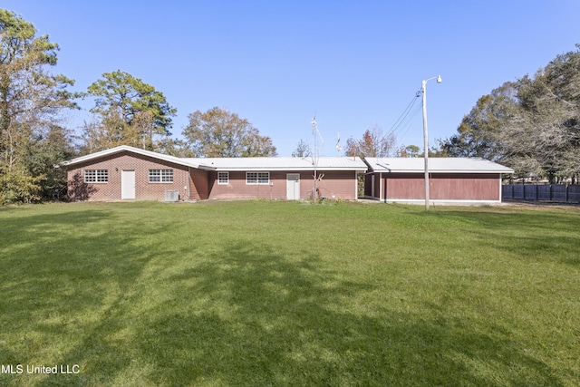 back of property with cooling unit and a yard