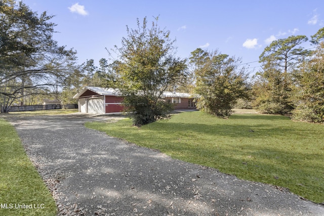 view of front of property with a front yard and a garage