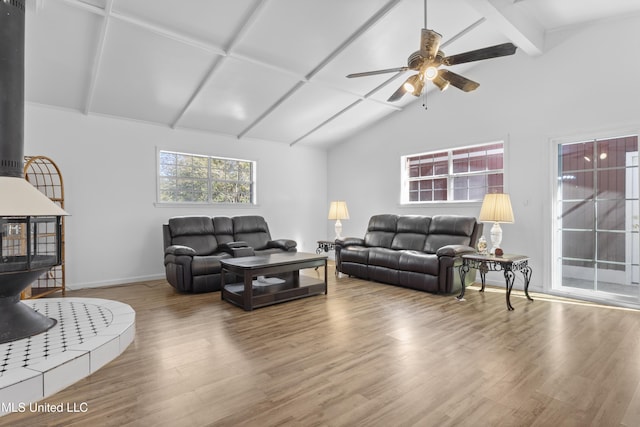 living room featuring ceiling fan, wood-type flooring, and vaulted ceiling