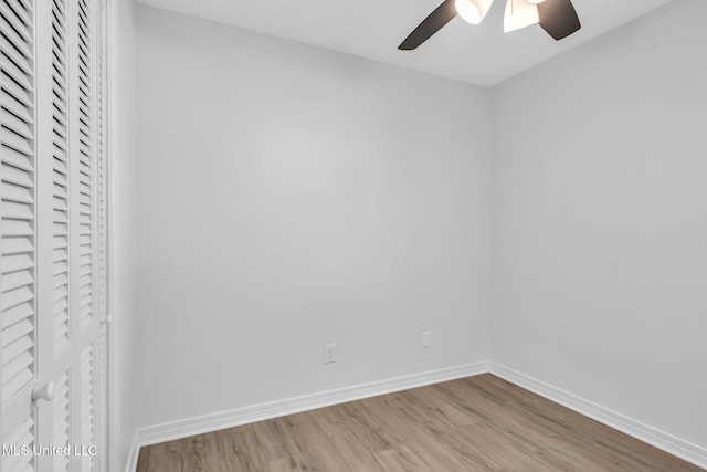 spare room featuring baseboards, ceiling fan, and wood finished floors