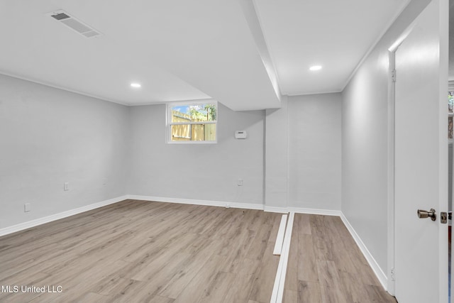 below grade area with recessed lighting, baseboards, light wood finished floors, and visible vents