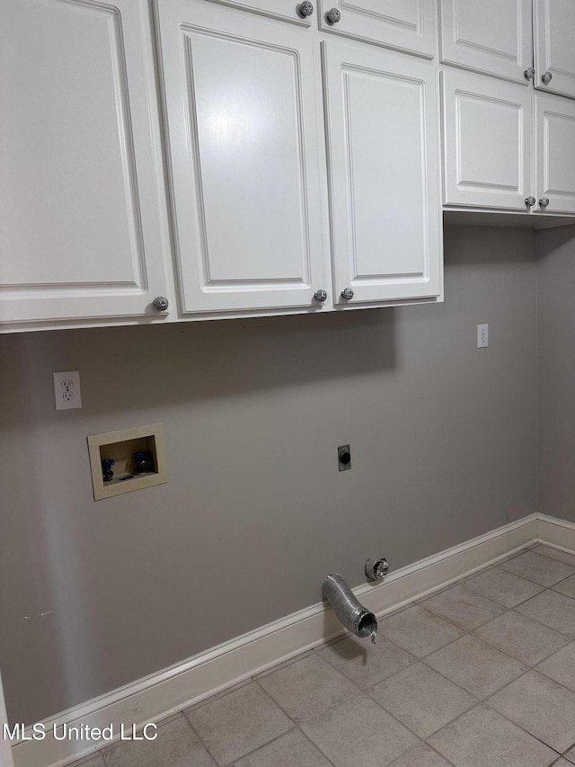 washroom with baseboards, cabinet space, electric dryer hookup, washer hookup, and hookup for a gas dryer