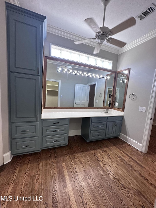 bathroom featuring visible vents, wood finished floors, a ceiling fan, and ornamental molding