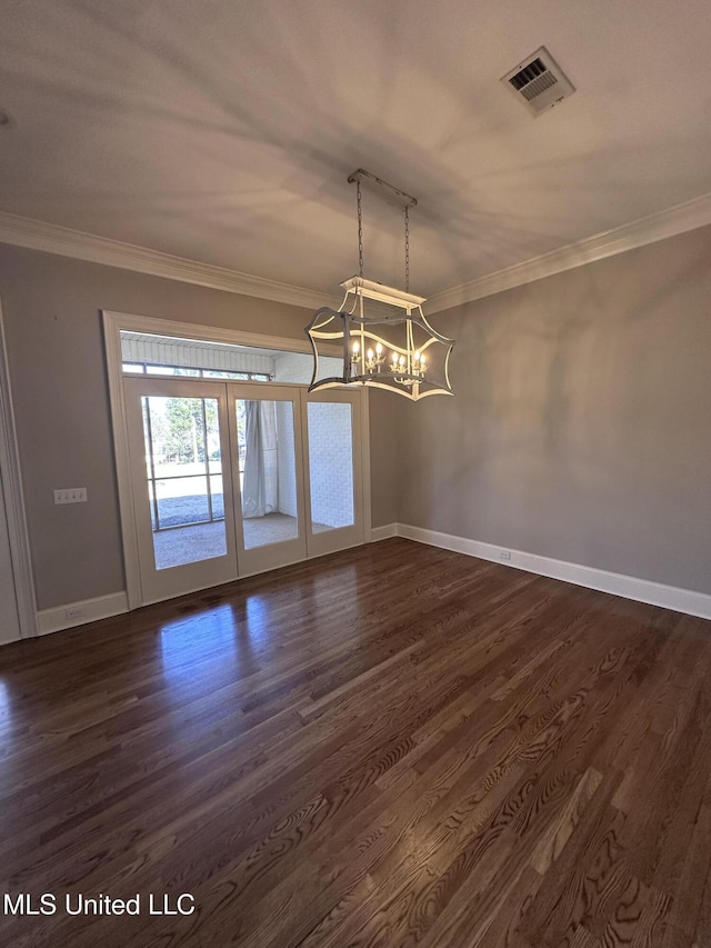 unfurnished dining area with dark wood-style floors, visible vents, crown molding, and baseboards