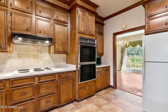 kitchen featuring decorative backsplash, crown molding, an inviting chandelier, light tile patterned floors, and white appliances