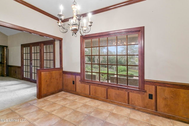 unfurnished dining area featuring a notable chandelier, ornamental molding, light tile patterned floors, and wooden walls