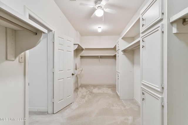 spacious closet featuring light carpet and ceiling fan