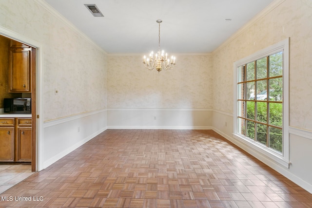 unfurnished dining area with crown molding, a chandelier, and light parquet flooring