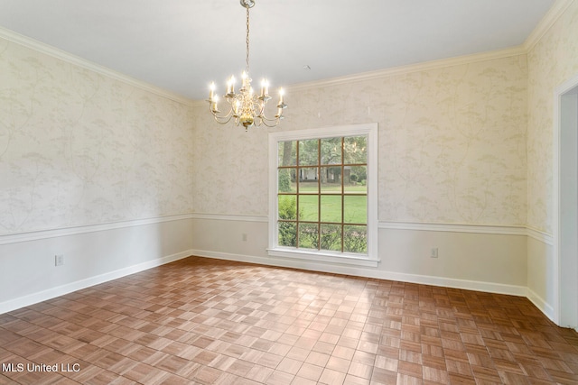 empty room with ornamental molding, a chandelier, and parquet floors