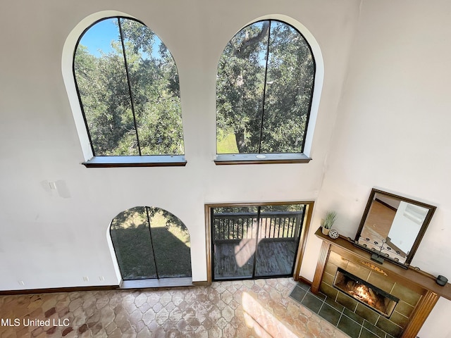 interior space featuring a fireplace and a high ceiling