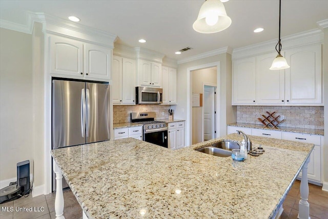 218 Greenfield Ridge Dr, Brandon, MS 39042 - kitchen with stainless steel appliances, a sink, white cabinets, light stone counters, and crown molding