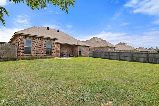 218 Greenfield Ridge Dr, Brandon, MS 39042 - back of house featuring brick siding and roof with shingles