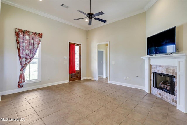 218 Greenfield Ridge Dr, Brandon, MS 39042 - unfurnished living room featuring a ceiling fan, light tile patterned flooring, crown molding, a tile fireplace, and baseboards