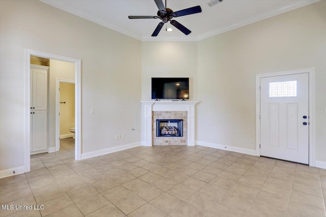 218 Greenfield Ridge Dr, Brandon, MS 39042 - unfurnished living room featuring ceiling fan, a tile fireplace, crown molding, light tile patterned flooring, and baseboards