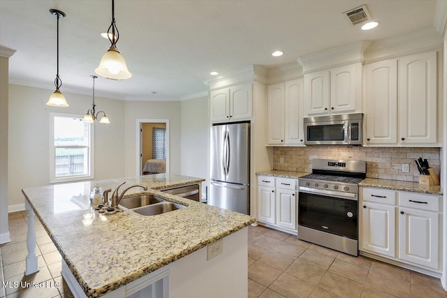 218 Greenfield Ridge Dr, Brandon, MS 39042 - kitchen with appliances with stainless steel finishes, a sink, tasteful backsplash, light tile patterned floors, and a kitchen island with sink