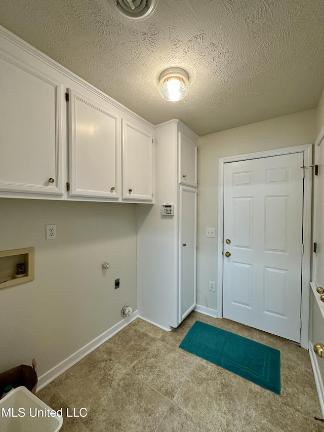 clothes washing area with a textured ceiling, washer hookup, electric dryer hookup, and cabinets