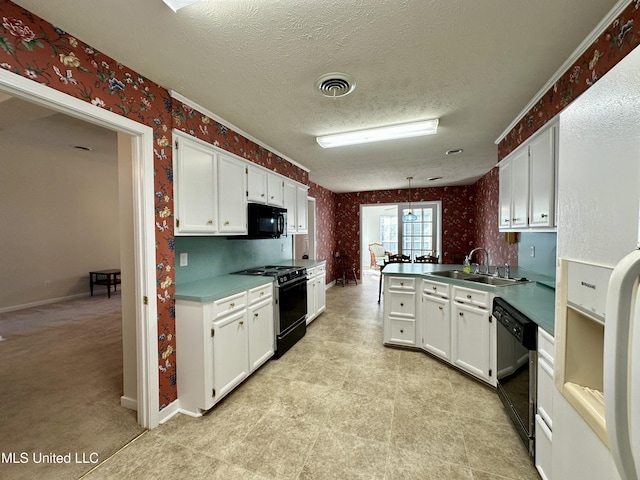 kitchen featuring kitchen peninsula, black appliances, pendant lighting, white cabinets, and sink