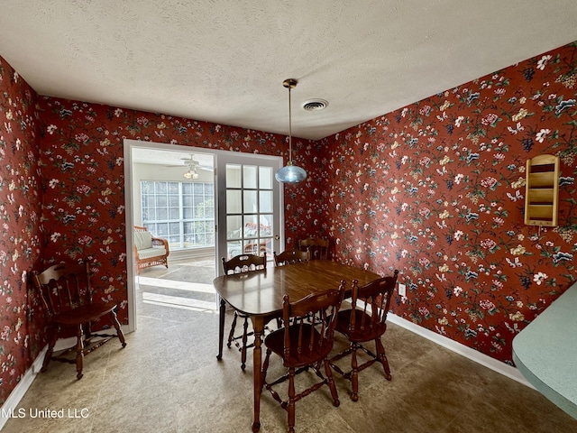 dining room featuring a textured ceiling