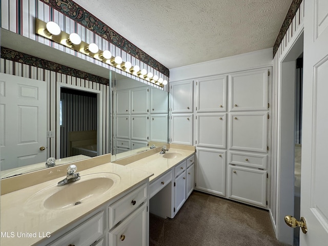 bathroom with a textured ceiling and vanity