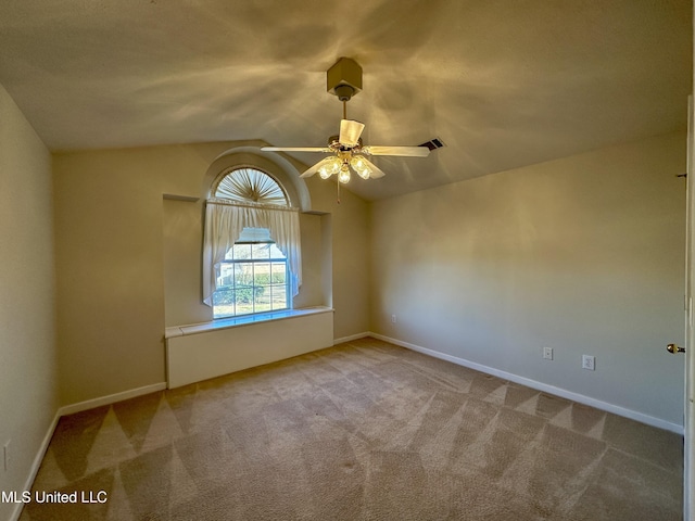 unfurnished room featuring vaulted ceiling, ceiling fan, and light colored carpet