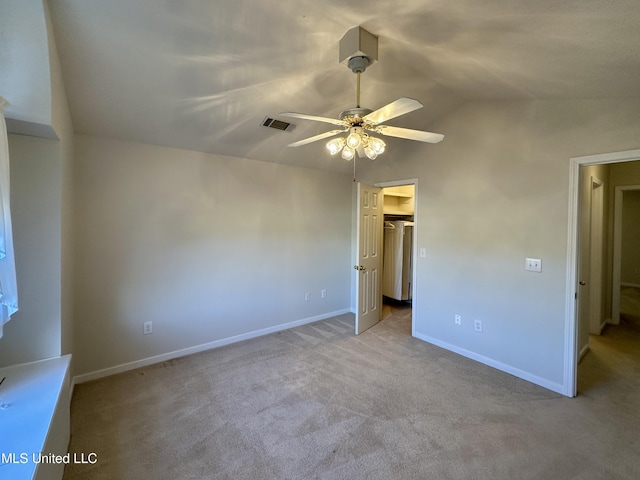 unfurnished bedroom featuring ceiling fan, light colored carpet, and lofted ceiling