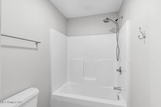 bathroom with washtub / shower combination and toilet