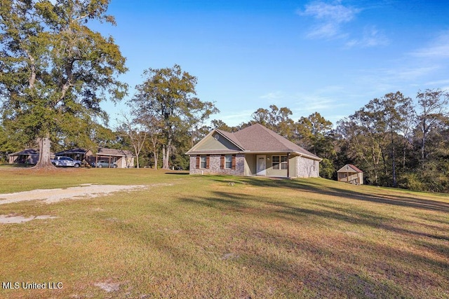 view of front of home featuring covered porch, a shed, and a front yard