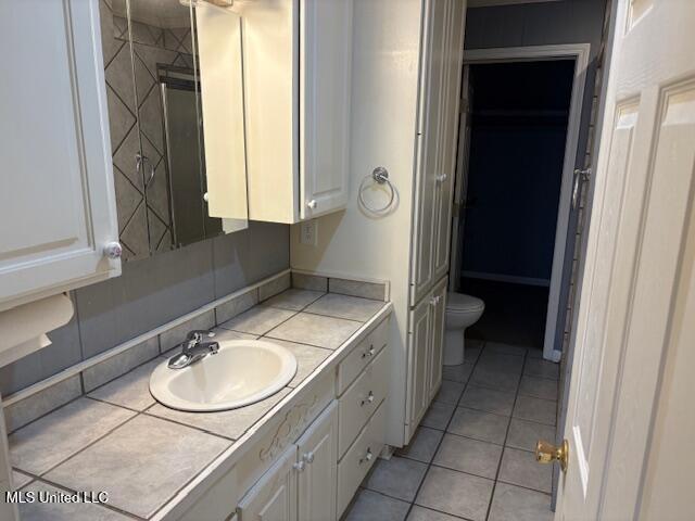 bathroom with tile patterned floors, toilet, and vanity