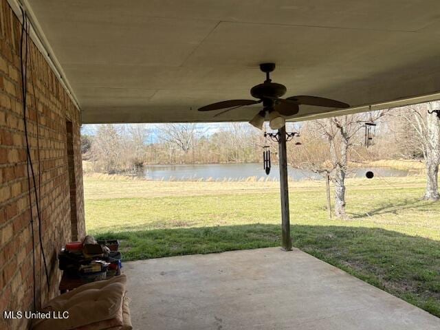 view of patio featuring a ceiling fan and a water view