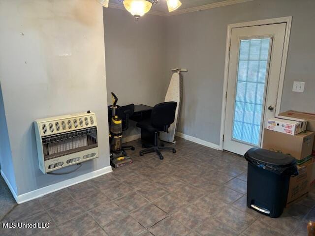 office with baseboards, heating unit, a healthy amount of sunlight, and crown molding