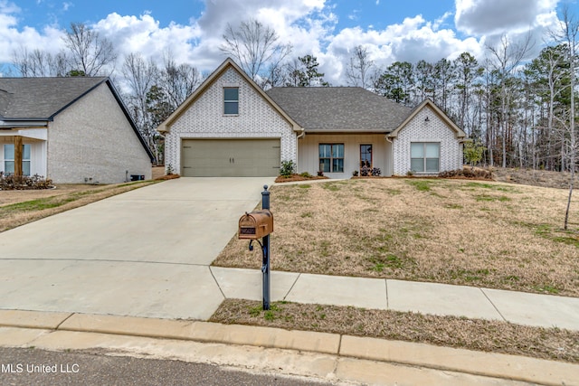 view of front of house with a front yard and a garage